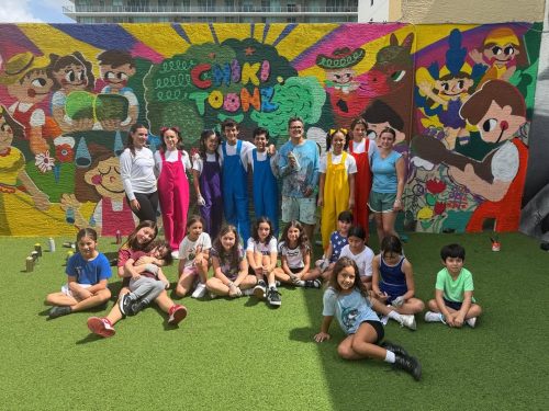 Students with wall art behind them